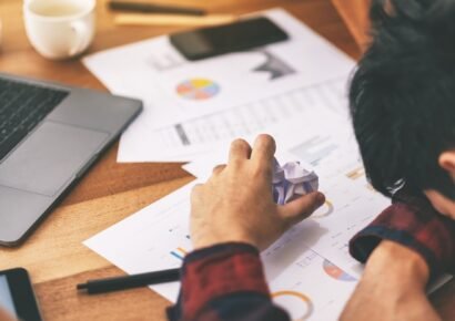 A businessman working with feeling frustrated and stressed with screwed up papers