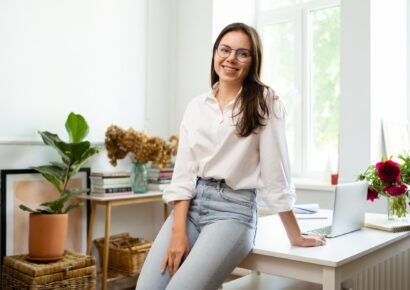 Businesswoman working on laptop computer sitting at home and managing her business via home office