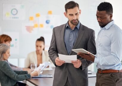 Consulting mentor, business men with a tablet and office employees work on creative design, digital