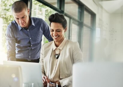 Giving her some feedback. Shot of two colleagues meeting in their office.
