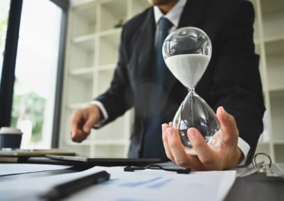 Hand of businessman holding hourglass. Business and time management concept