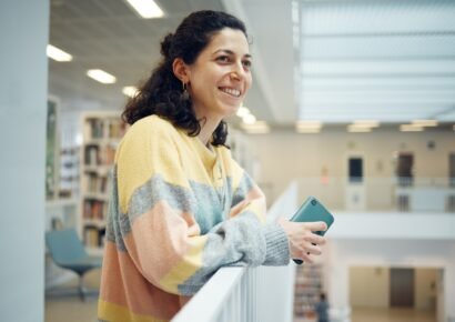 Library, happy student or intelligent woman with research goals, vision for success and excited for