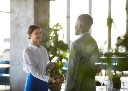 Pretty business lady shaking hand of business partner