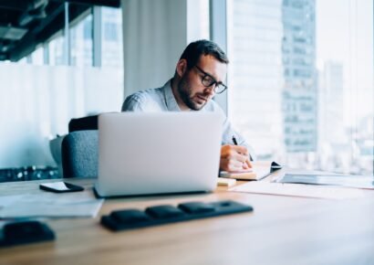 Serious businessman making notes in office