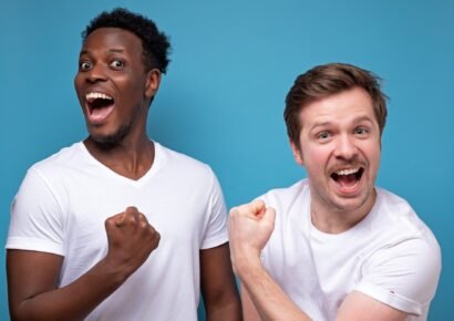 successful men raise fists, tell yes, feel joyful and proud of themselves, have happy expressions