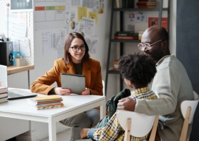 Teacher having meeting with parent of schoolboy