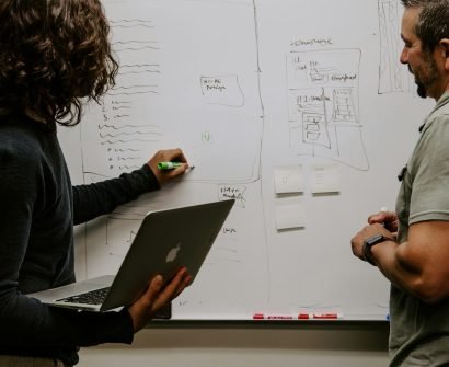 SWOT man wearing gray polo shirt beside dry-erase board