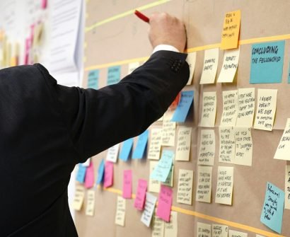 sticky notes on corkboard PROJECT MANAGER